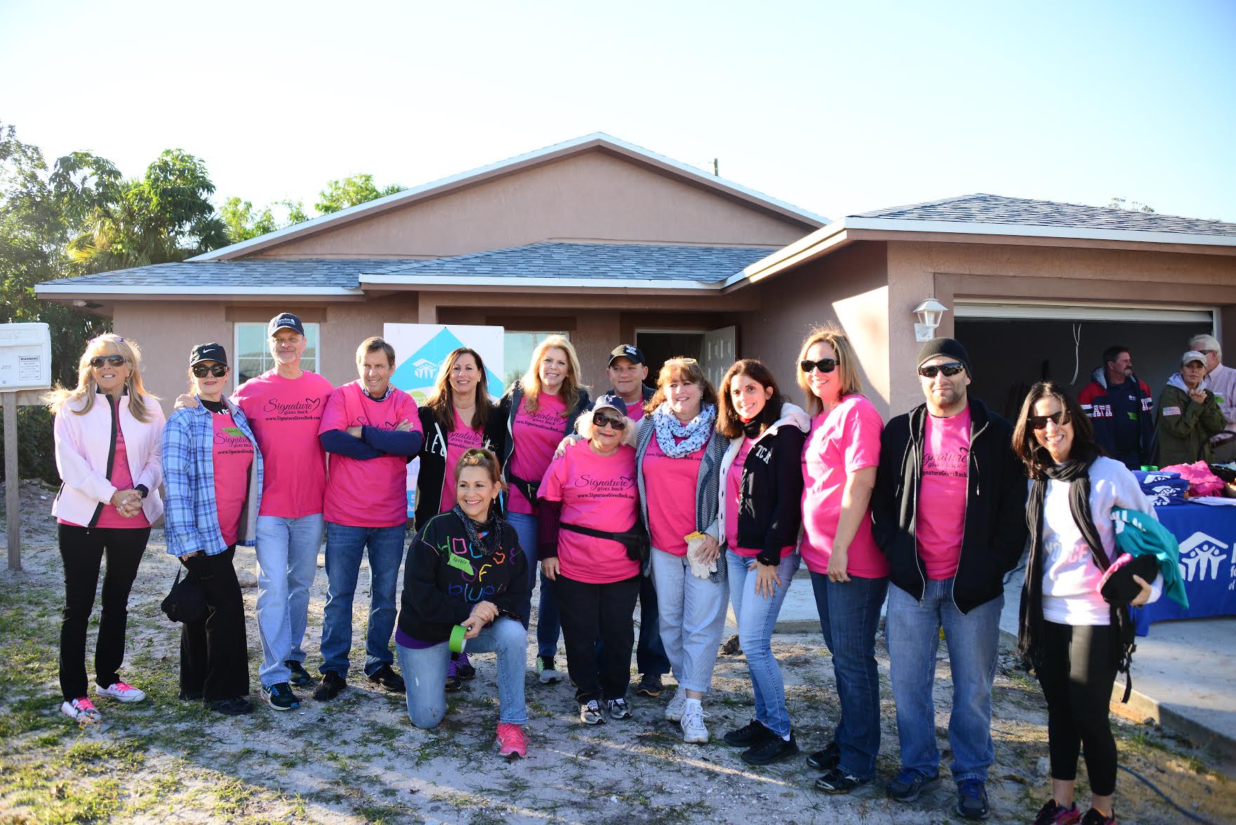Signature Gives Back volunteering for Habitat for Humanity