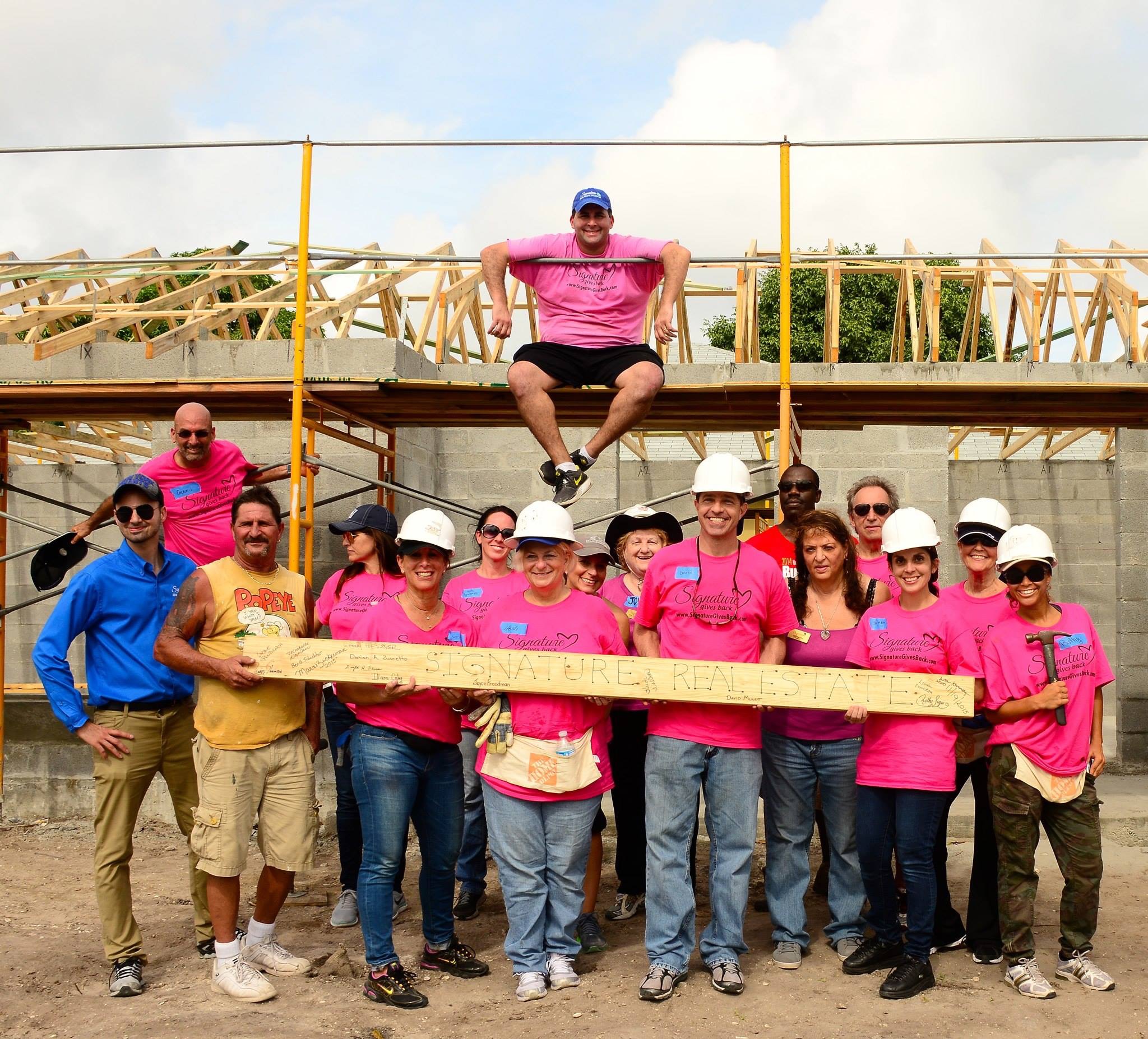 Signature Gives Back volunteering for Habitat for Humanity